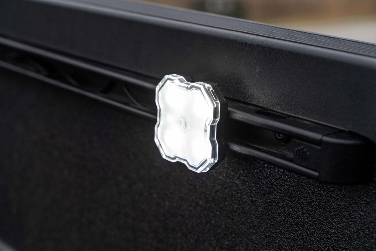Diode Dynamics LED rock light mounted to Toyota Tacoma bed rail