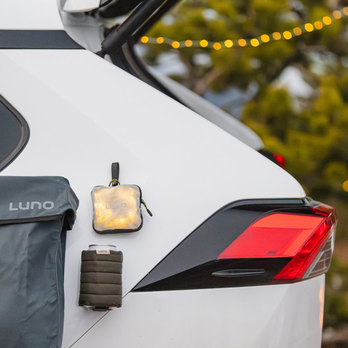 Luno Magnetic Can Cooler attached to SUV exterior while vehicle camping